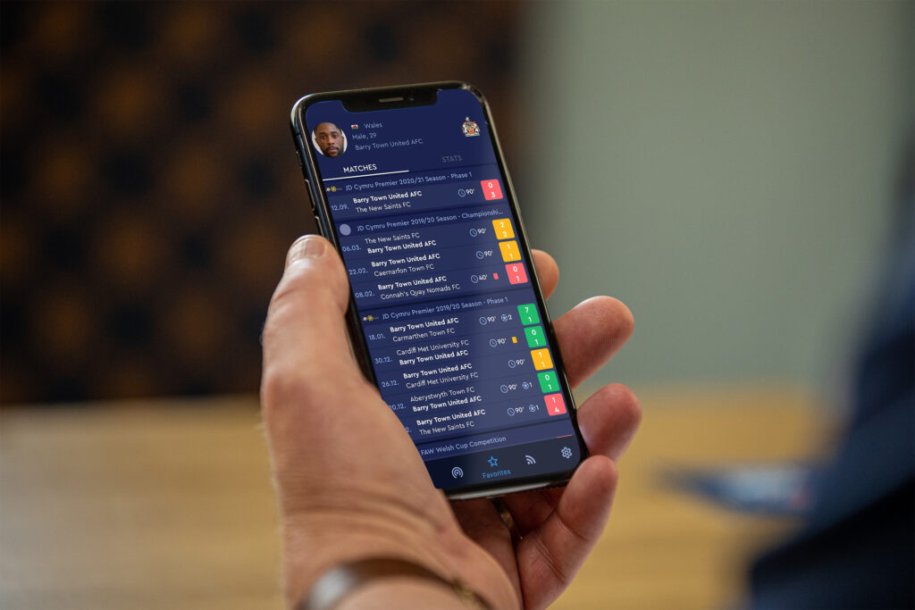 A user access the Cymru Football App to check the latest football results.