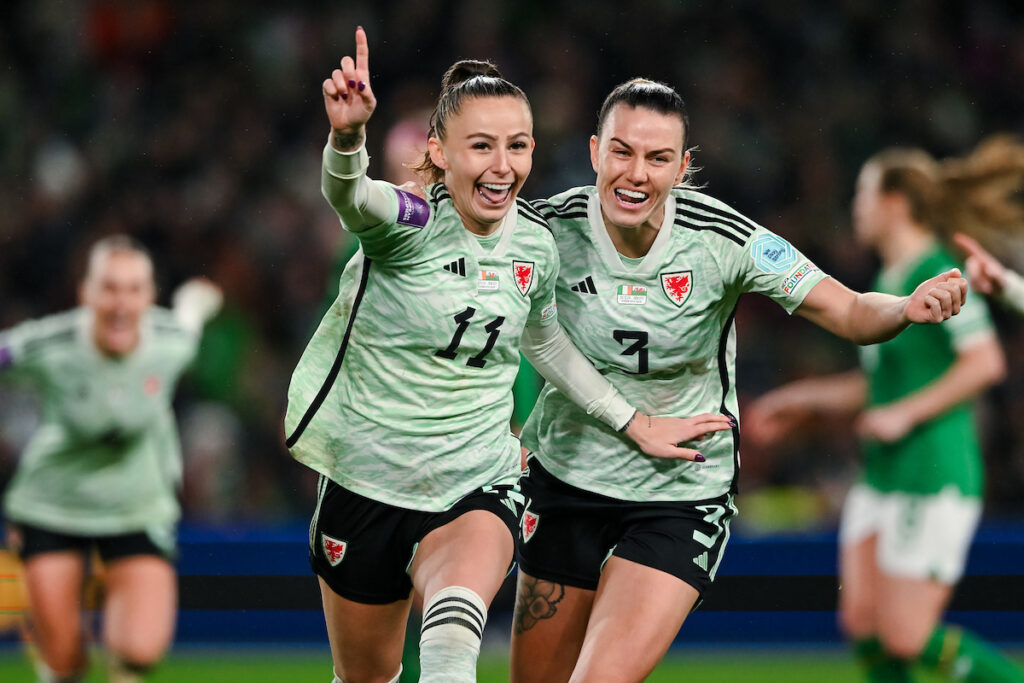 Hannah Cain celebrates scoring for Cymru in a UEFA Women's EURO 2025 play-off match.