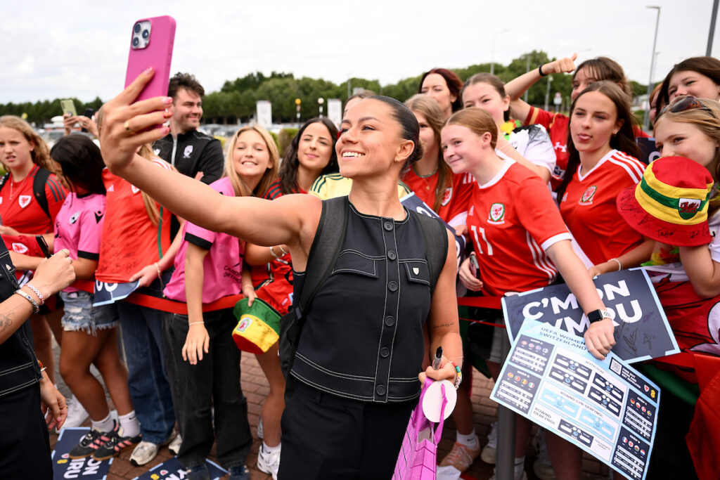 Ffion Morgan takes a selfie with Cymru supporters at Cardiff Airport